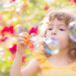 Kid blowing soap bubbles